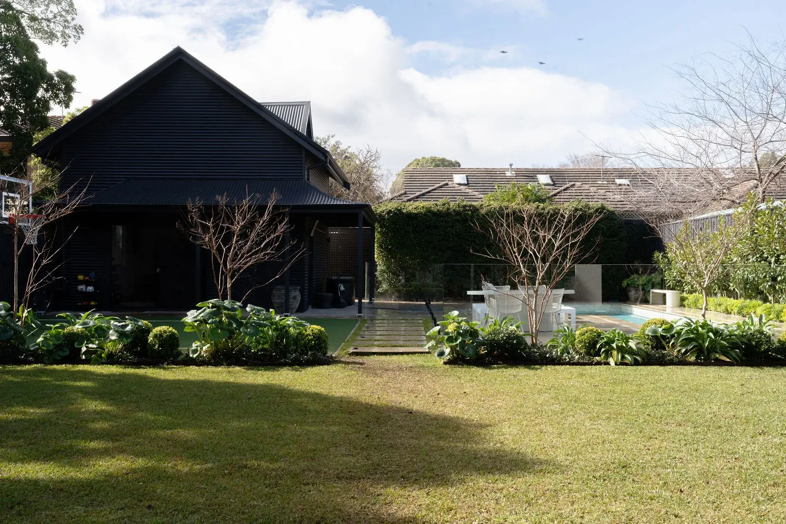 Rear lawn with the guest residence and pool beyond