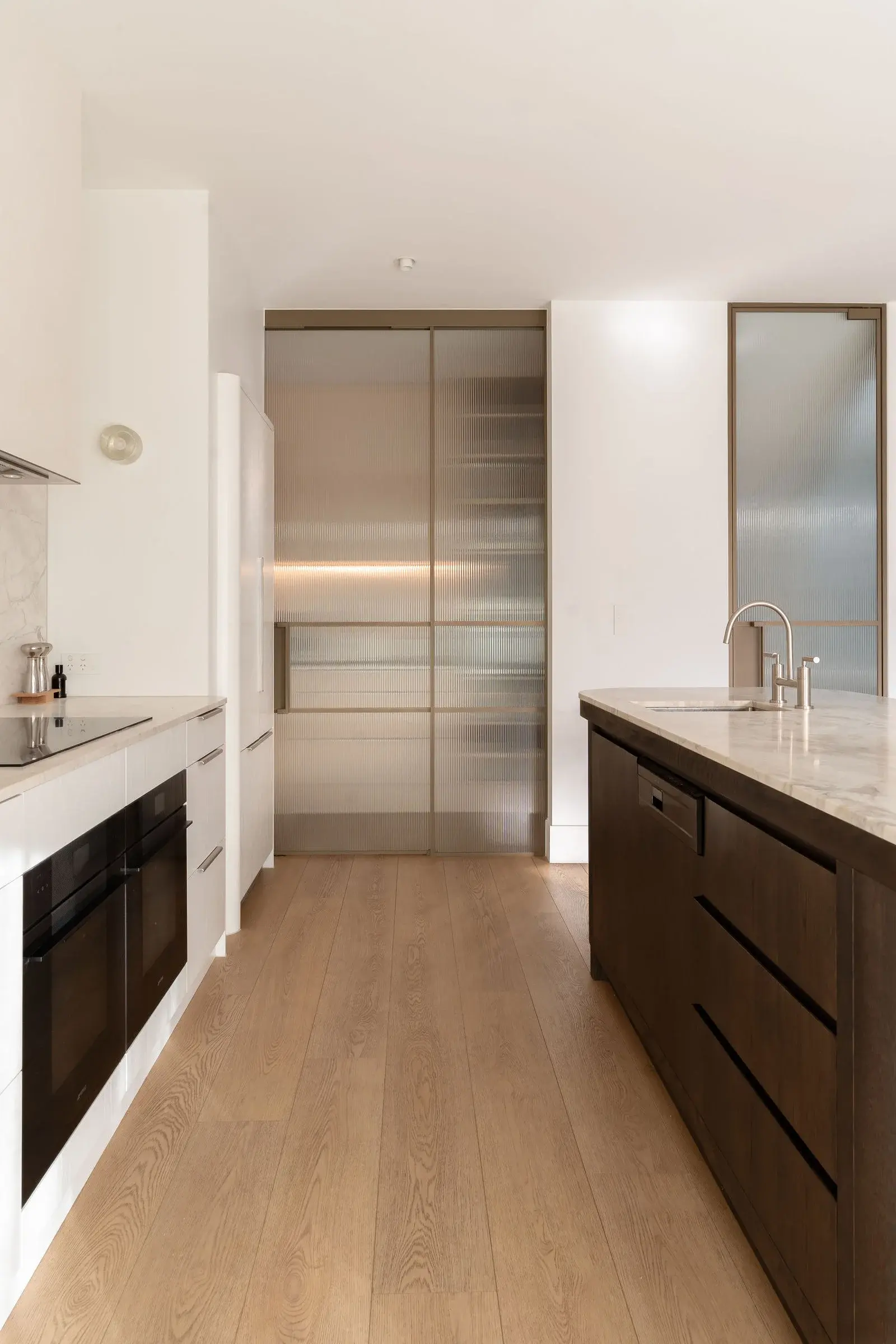 Kitchen with stone island and fluted-glass butler's pantry